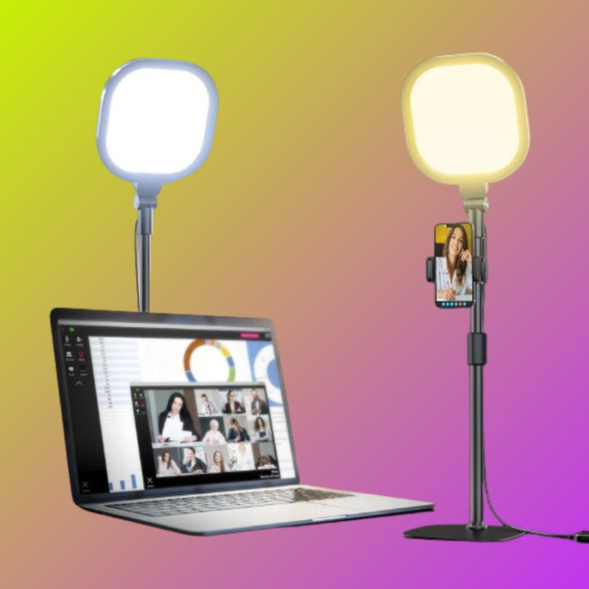The LitONES desk ring light on its adjustable stand, positioned to one side of a desk as a fill light rather than facing the camera straight on.