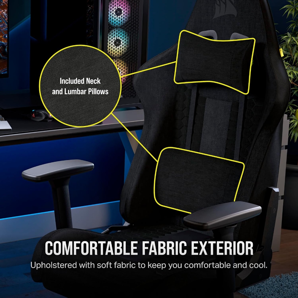 Black fabric Corsair TC100 Relaxed at a gaming desk, with its neck pillow and lumbar pillow highlighted